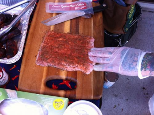 Johnny McLaughlin of Heartbreaking Dawns rubbing down some python snake meat.