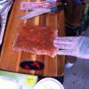 Johnny McLaughlin of Heartbreaking Dawns rubbing down some python snake meat.