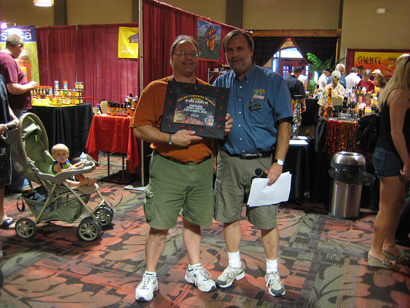 Jim Beckett of Jungle Jim's handing Chuck Evans of Montezuma the 1st Place award